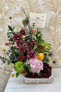 F-03  Canasta de mimbre con orquídeas y frutas